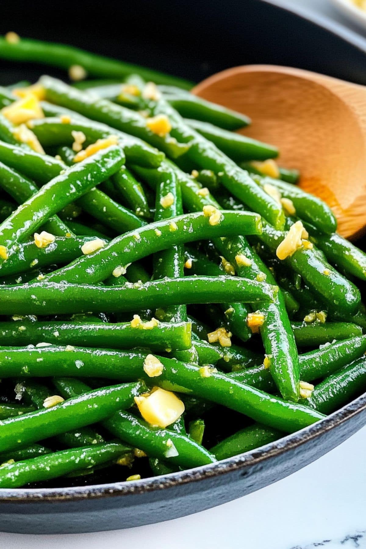 Green beans with butter and garlic tossed in a skillet pan.