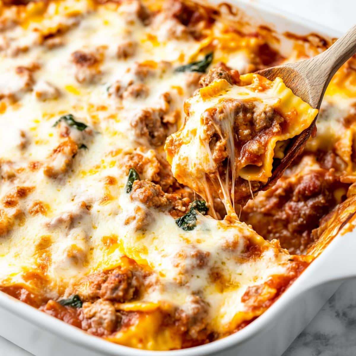 Italian sausage, frozen ravioli and cheeses in a casserole.