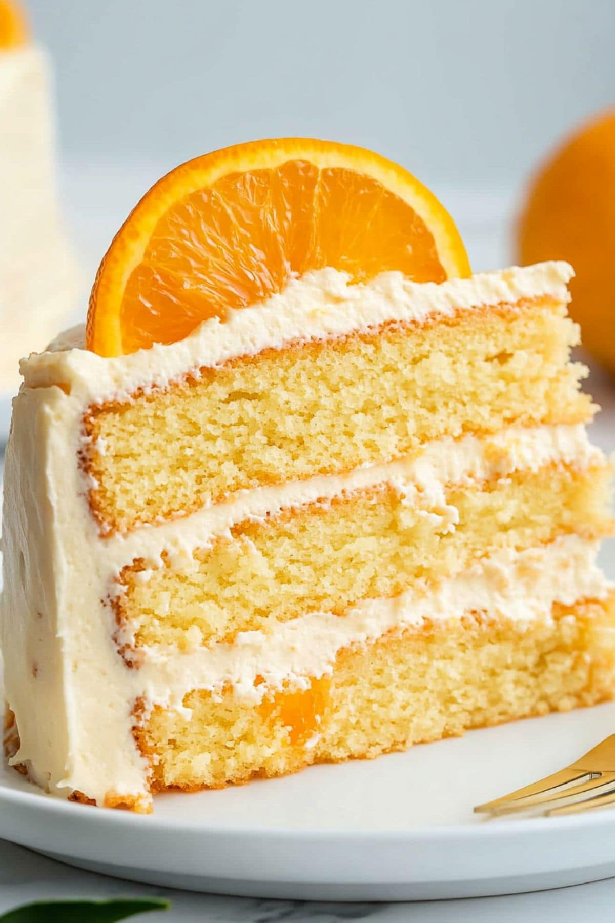 Slice of pig picking cake served on a white plate garnished with orange slice.