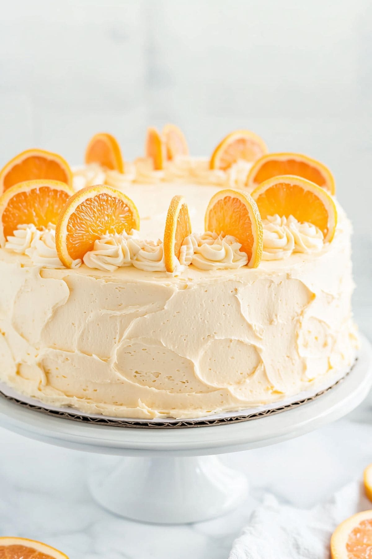 Orange pig pickin' cake covered with frosting sitting on a cake tray.