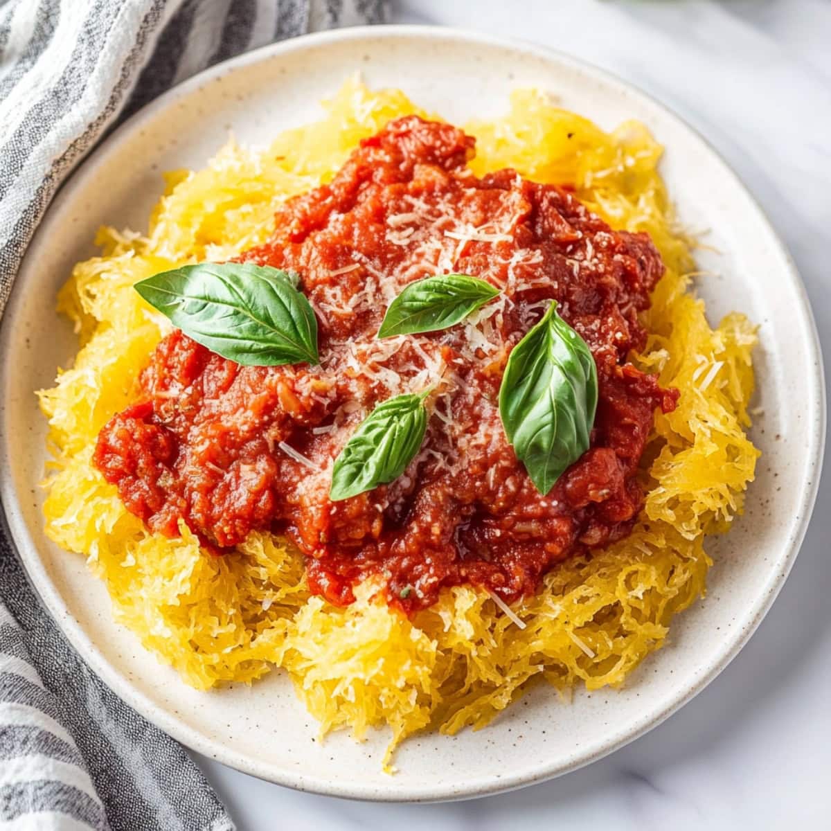 An overhead view of spaghetti squash marinara in a plate.