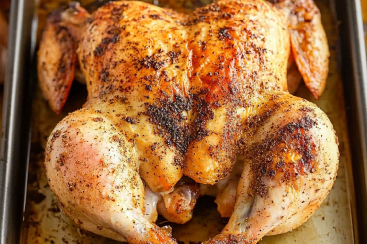 Roasted chicken with spices in a sheet pan.