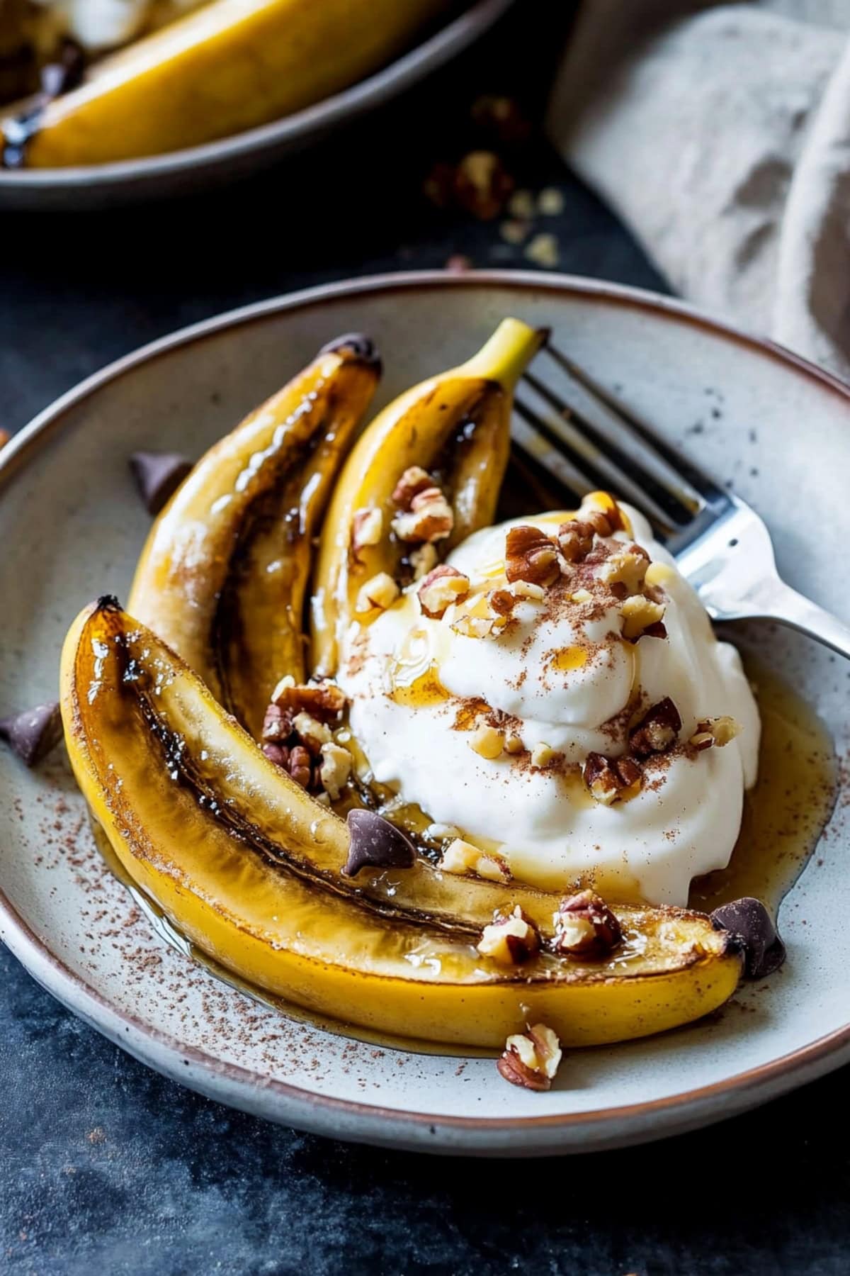 Baked bananas with chocolate chips, ice cream and nuts.