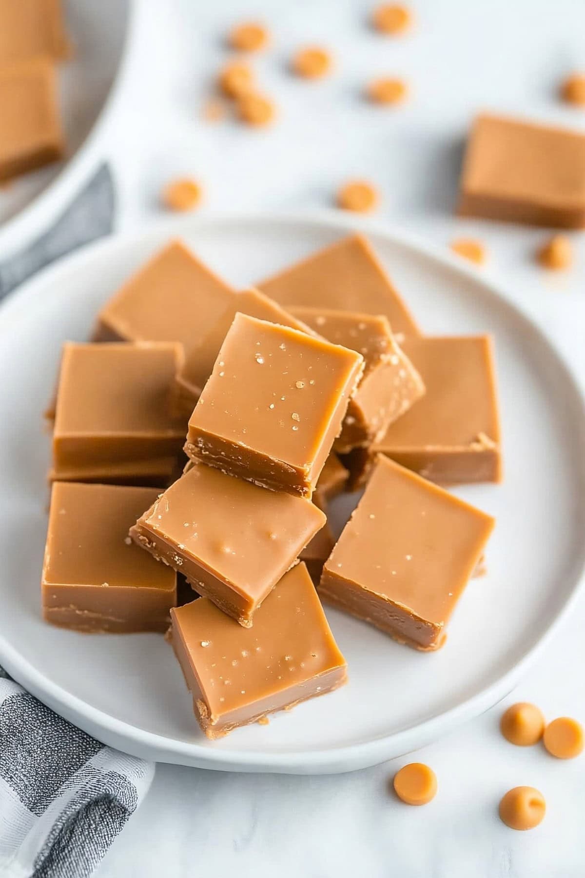 Sweet homemade butterscotch fudge stacked on a plate.