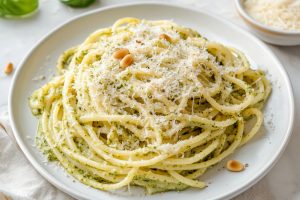 A plate of creamy lemon pesto pasta with grated parmesan cheese.