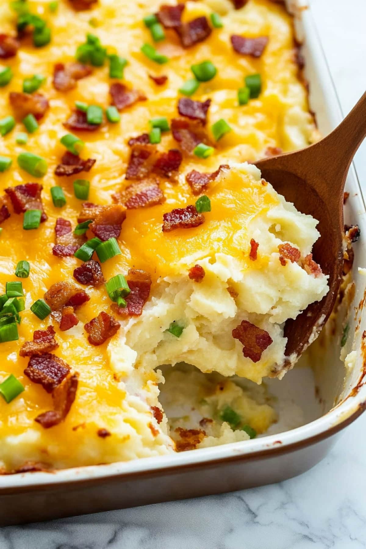 Golden-brown baked potato casserole with cheesy layers and a garnish of fresh parsley.