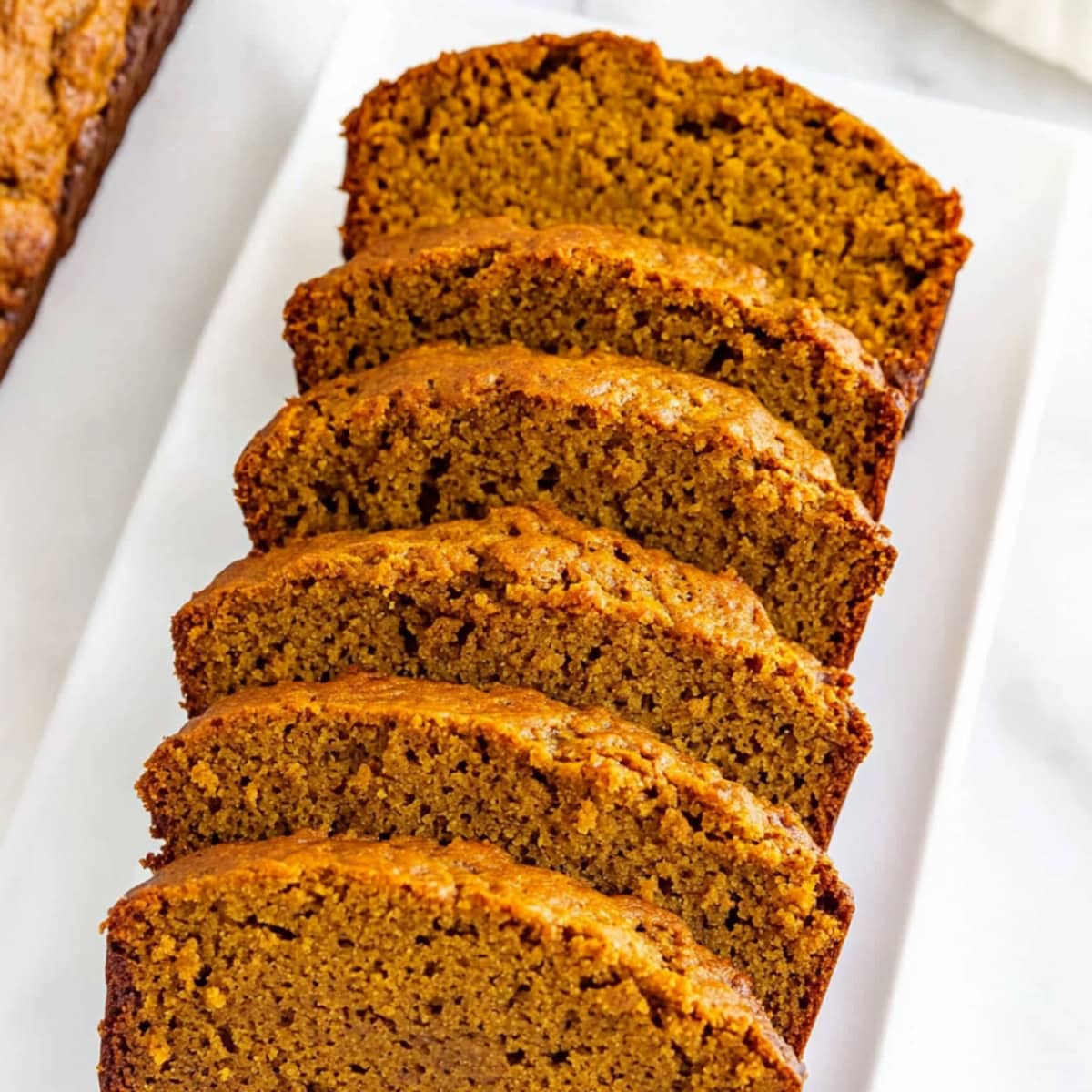 Moist slices of pumpkin banana bread on a plate,