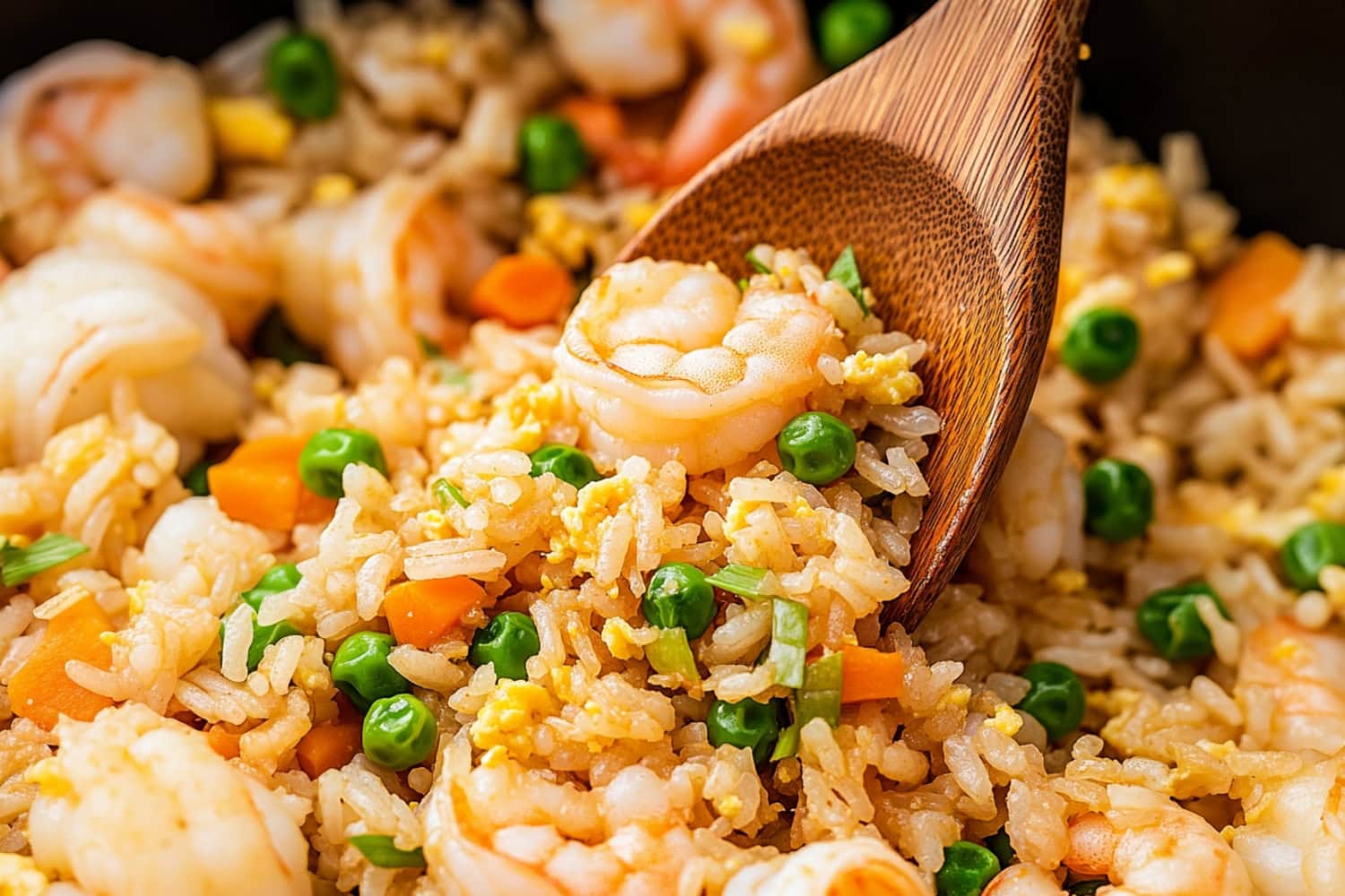 Close-up of shrimp fried rice: egg, mixed stir-fried vegetables, sprinkled with chopped green onions.