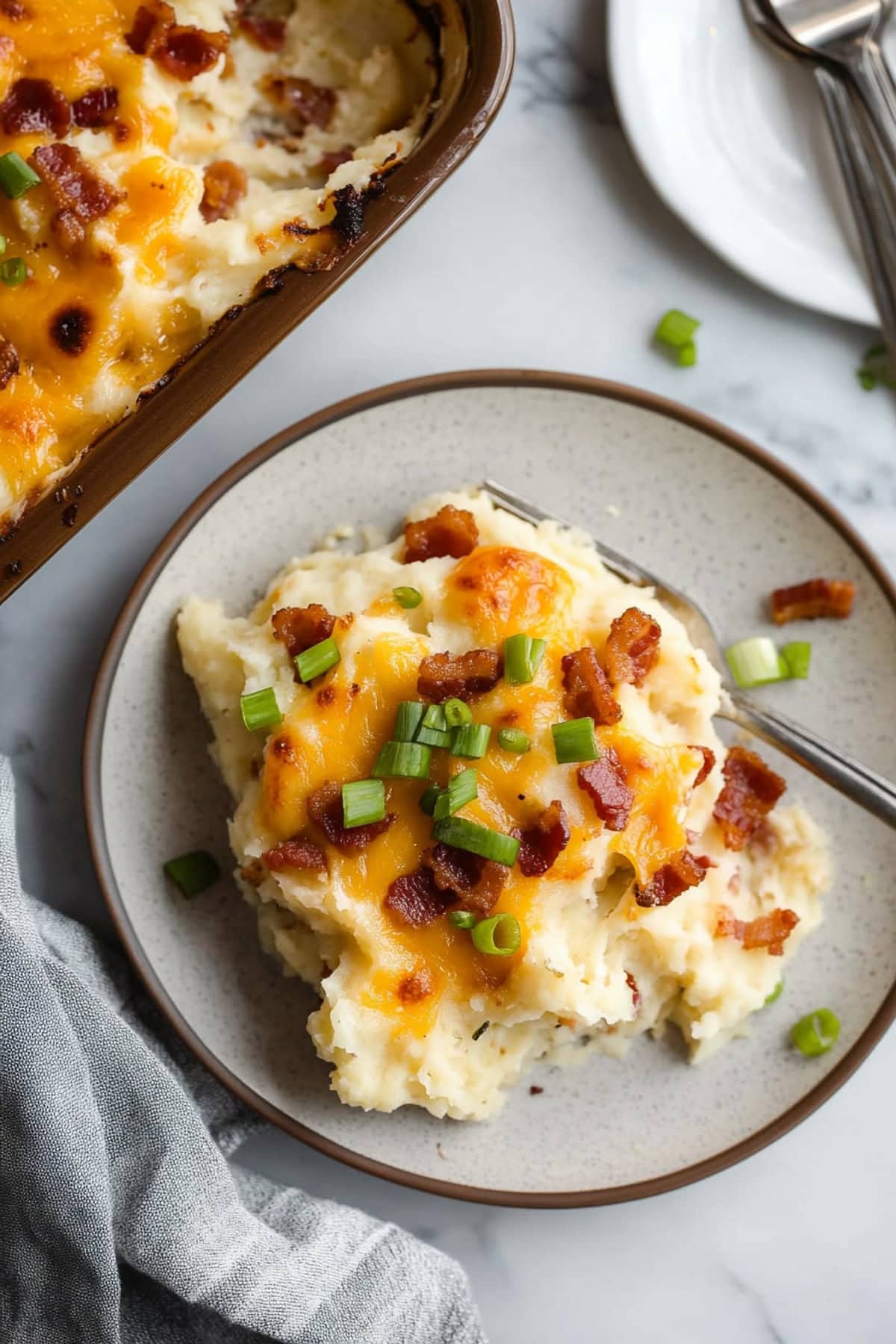 Cheesy loaded baked potato casserole with bacon and chopped green onions.