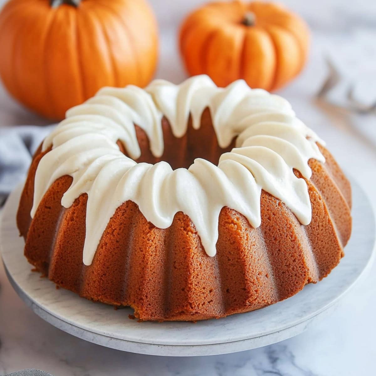 Pumpkin rich moist cake with cream cheese glaze on top.