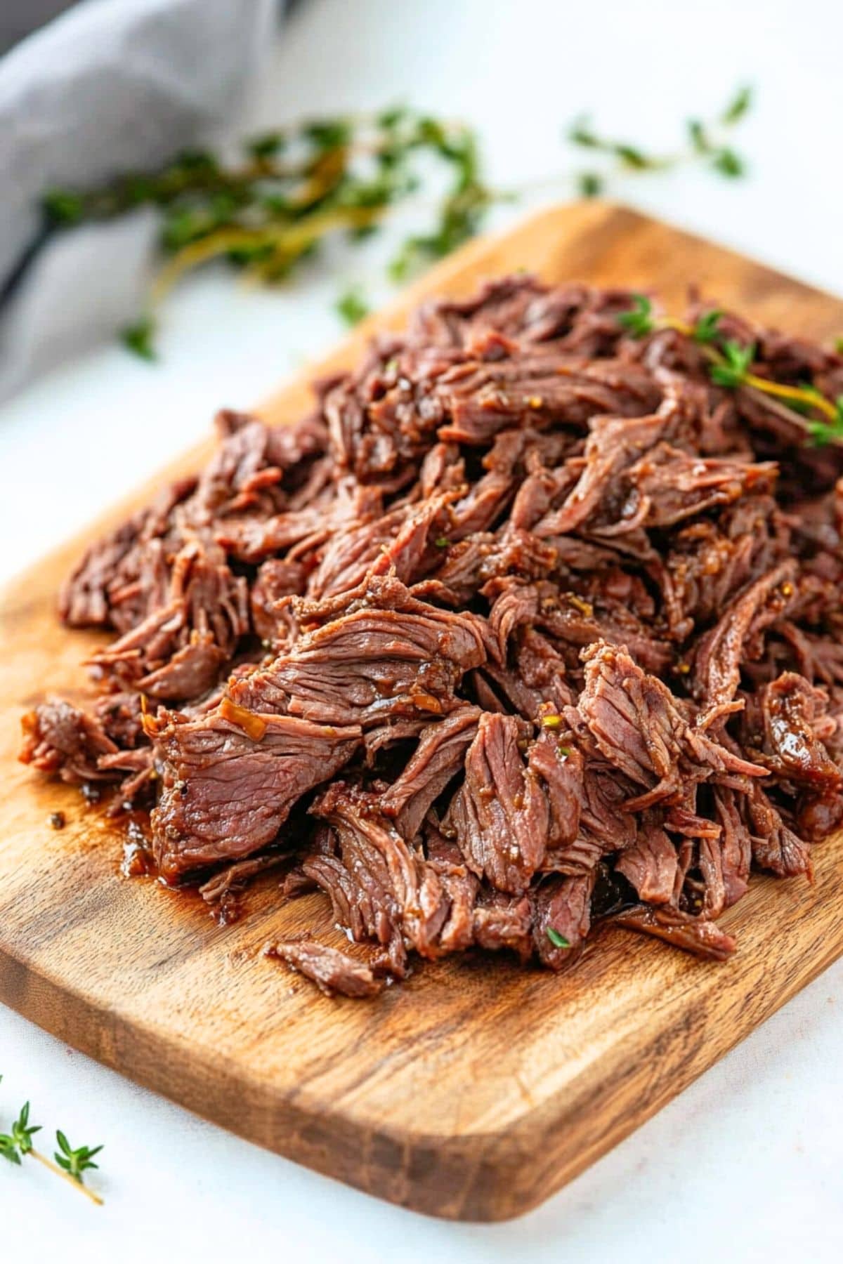 Shredded beef in a wooden board.