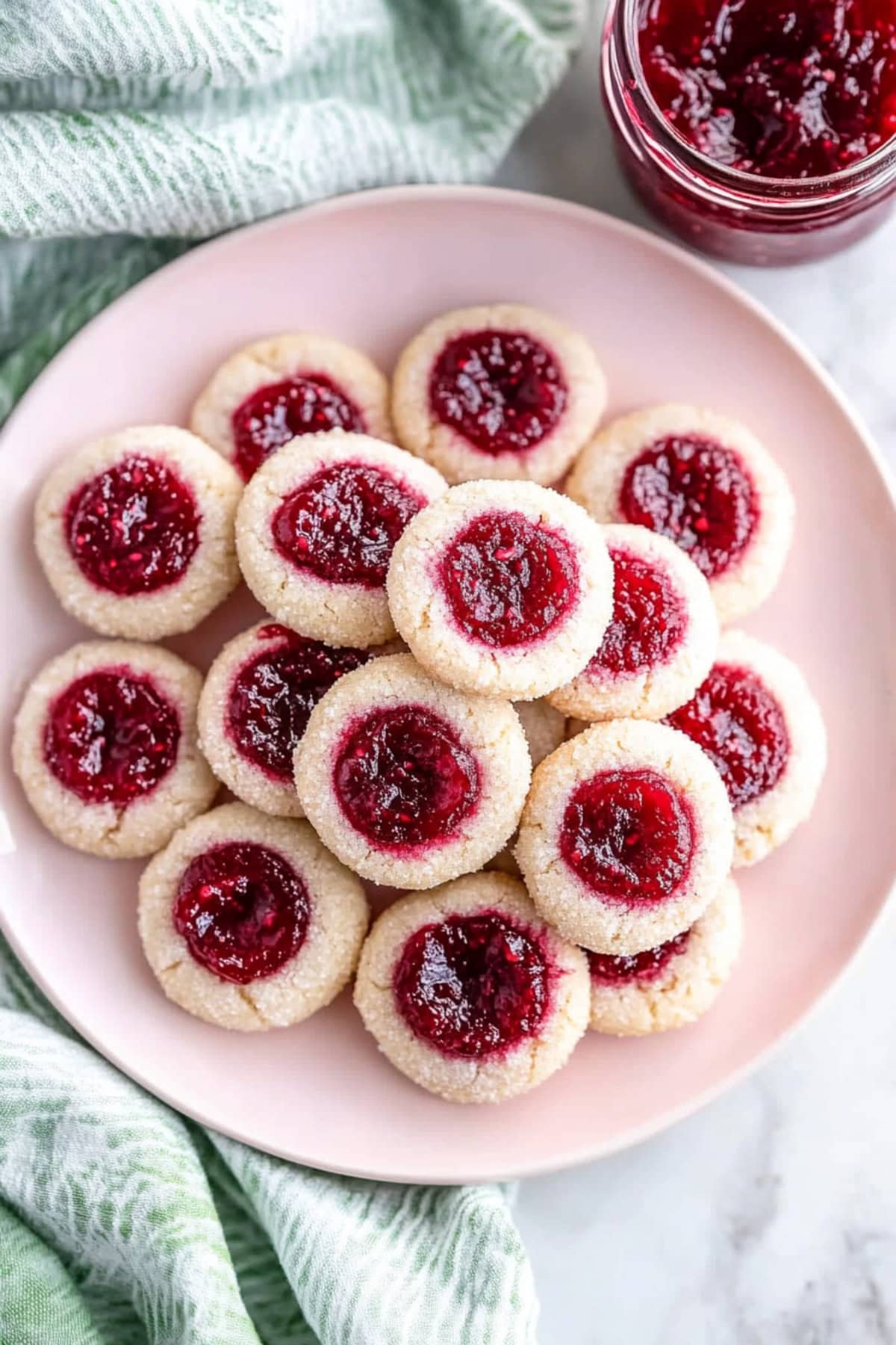 An overhead view of raspberry thumbprint cookies.