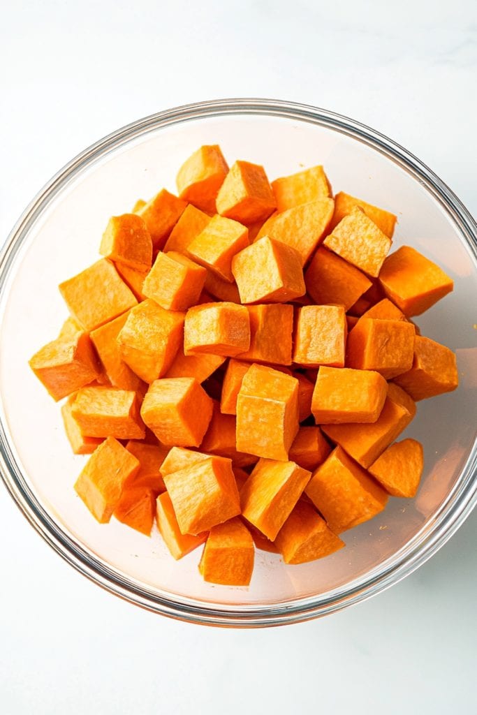 A glass bowl of sweet potato cubes.