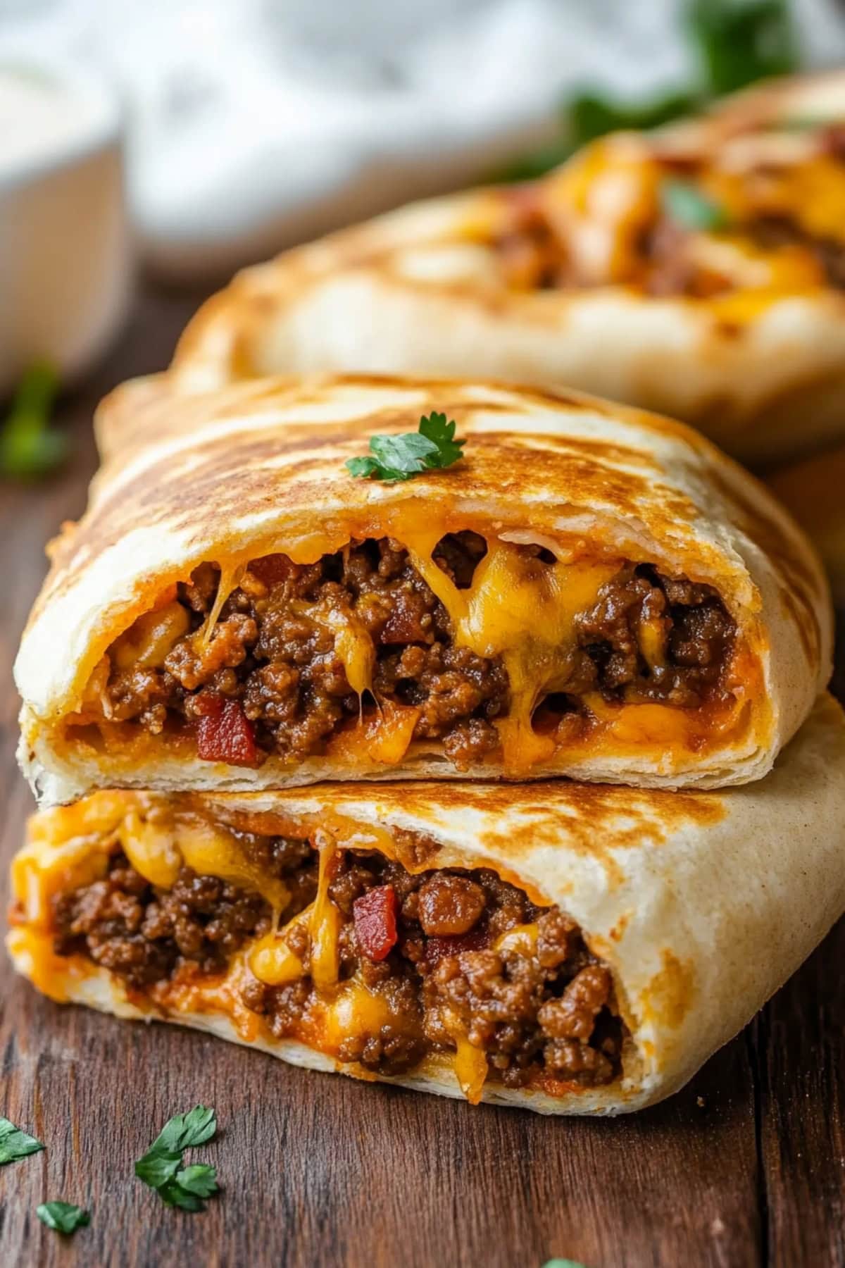 A stack of cheesy garbage bread with ground meat and bacon.