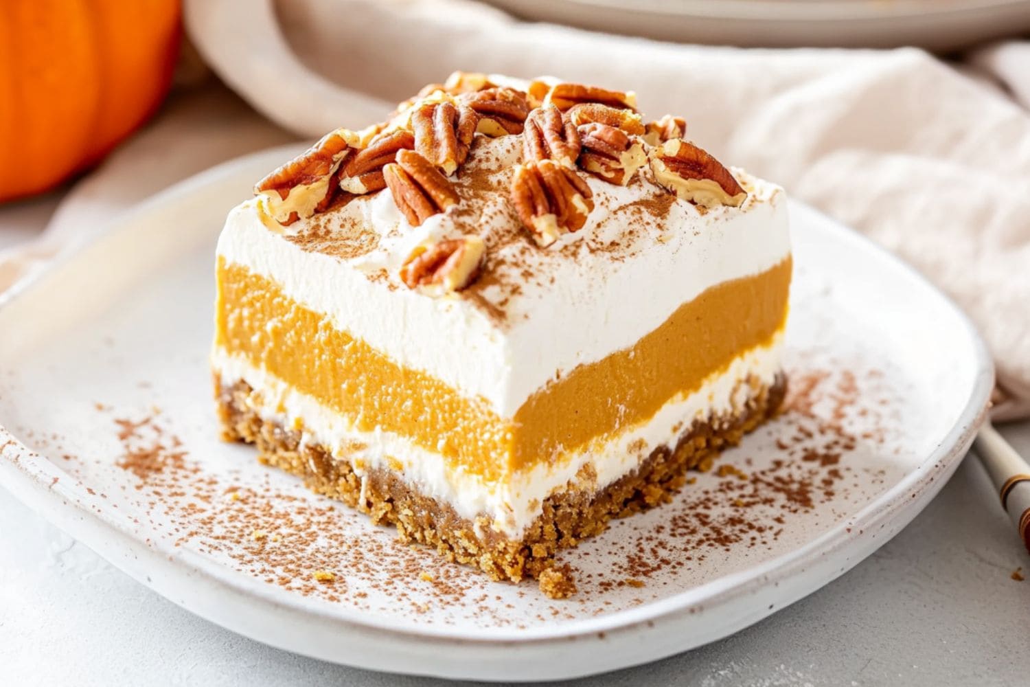 Square slice serving of pumpkin delight served in a white plate.