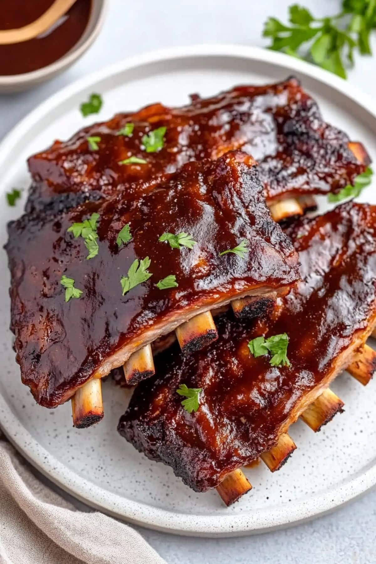 baby back ribs barbeque ribs slices in a white plate.