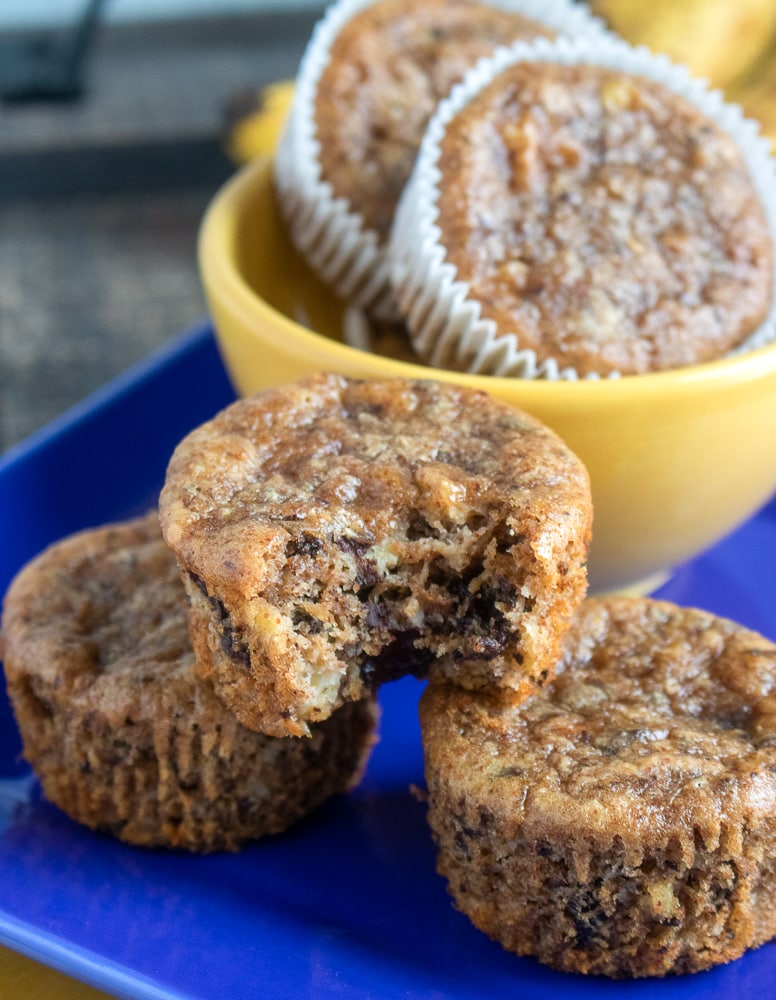 Banana chocolate chunk muffins served on a blue plate. 